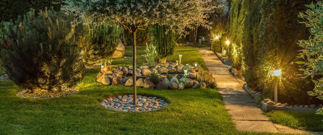 yard enhancement services. Private garden in the evening, illuminated by landscape lighting